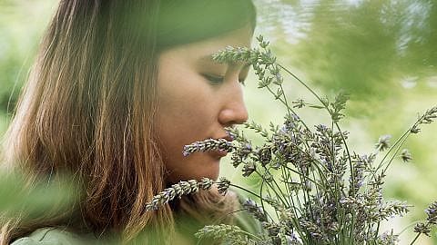 Woman smelling flowers