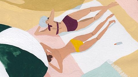 women laying at beach