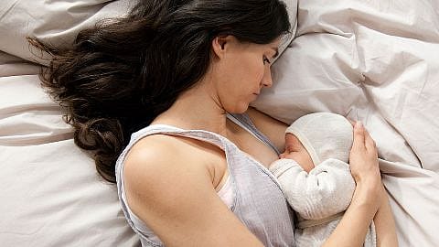 Mother laying down with baby