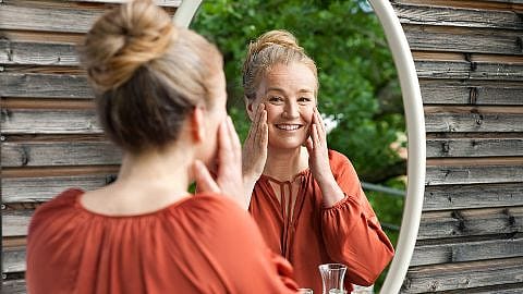 Woman seeing herself on a mirror