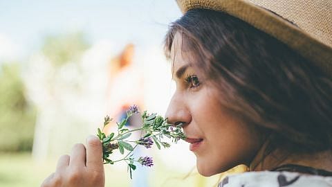 Girl smelling flowers