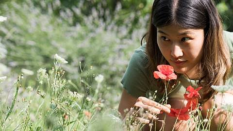 Woman smelling flowers