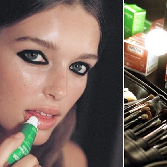 Model with dark eyeliner applying Skin Food Lip Balm.
