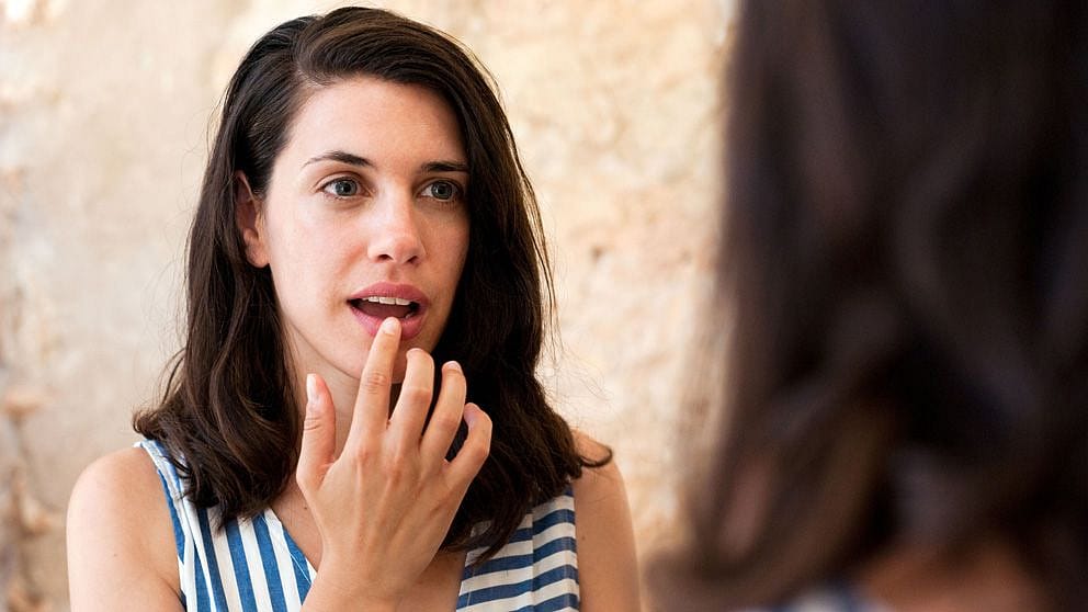 Woman touching her lips.