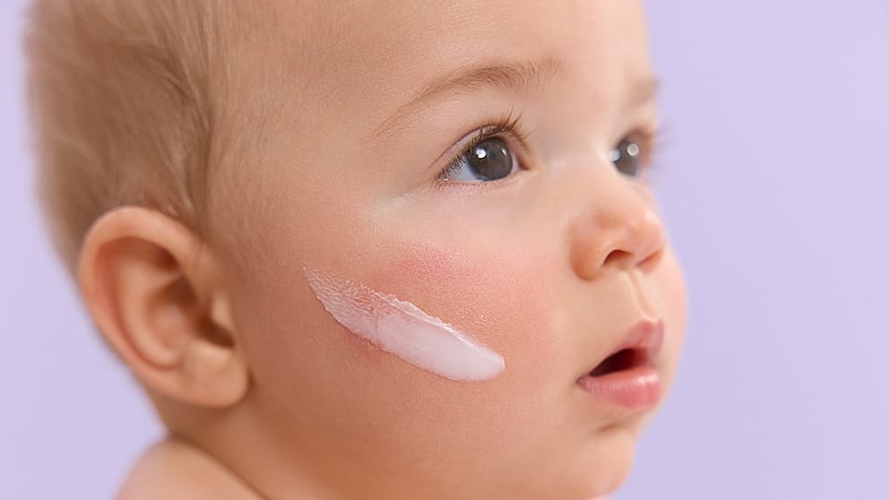 Baby with creamy texture on his face