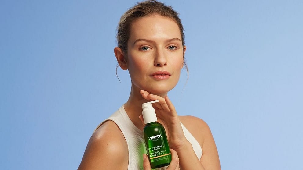Woman holding Weleda Cleanser