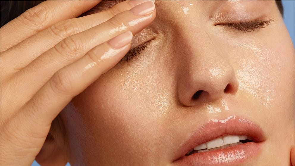 Woman removing her make-up with oil cleanser