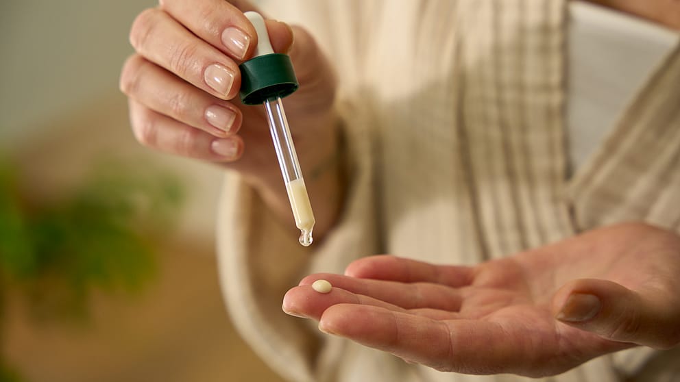 Serum in pipette being added to finger tips.