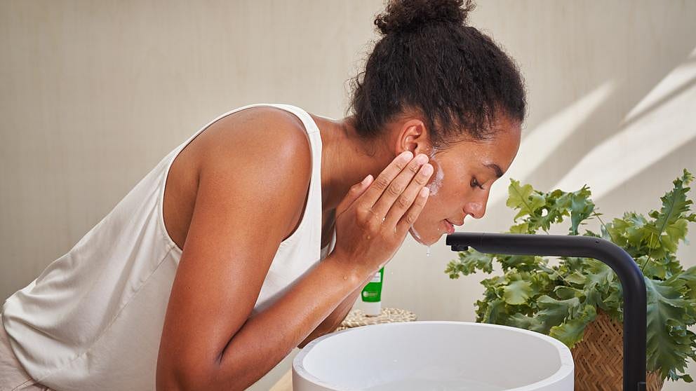 Woman washing face.