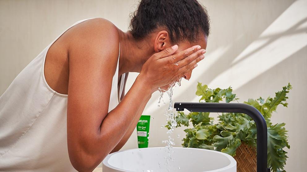 Woman washing face.