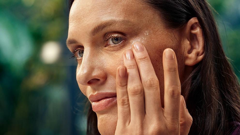 Woman applying eye cream