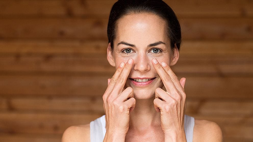 Woman applying eye cream