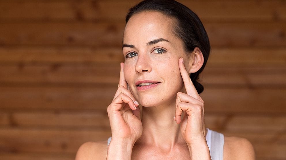 Woman applying face cream