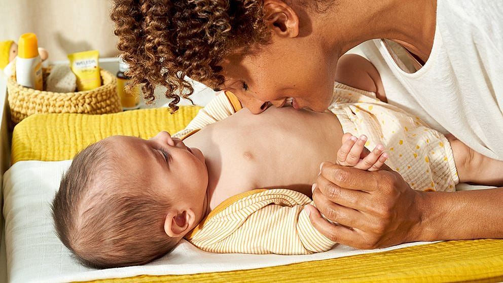 Mother kissing baby's tummy