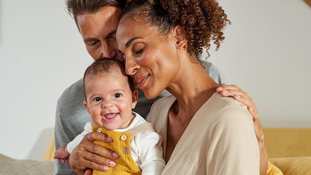 Parents sharing tender moment with child