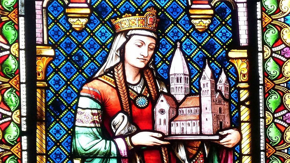 Glass mural of woman holding a church.