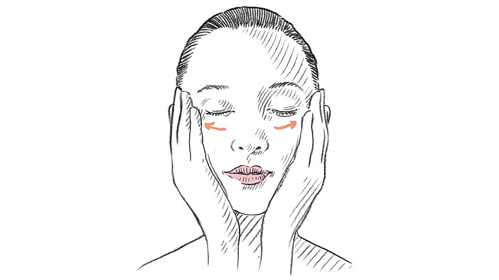 Facial massage drawing with arrows under eyes pointing outwards.