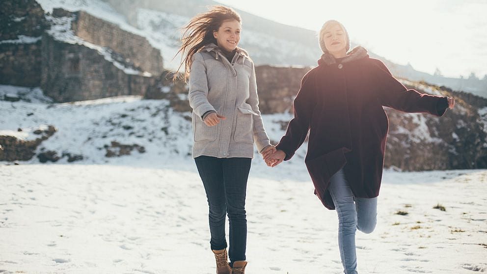 Couple holding hands in the snow