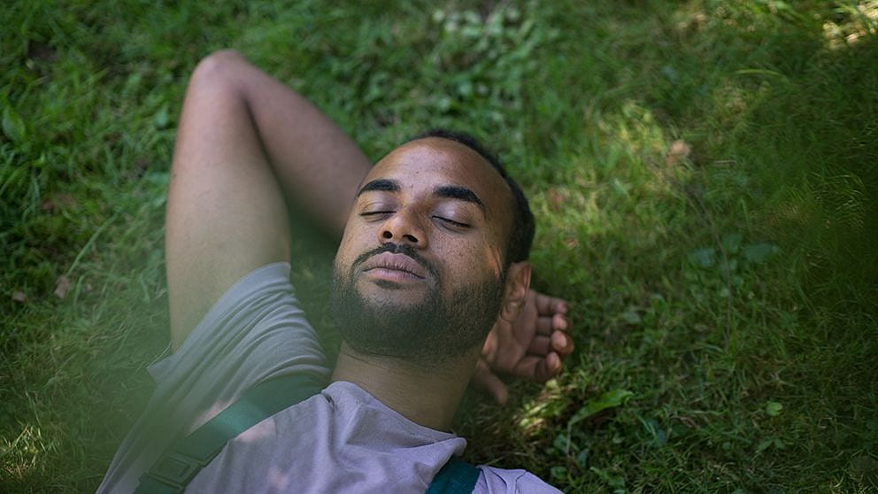 Man sleeping on grass.