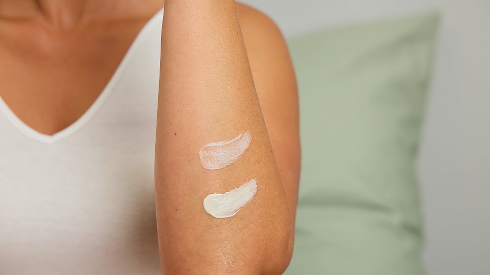 Textures of Weleda Skin Food Original and Skin Food Light on a woman's arm.