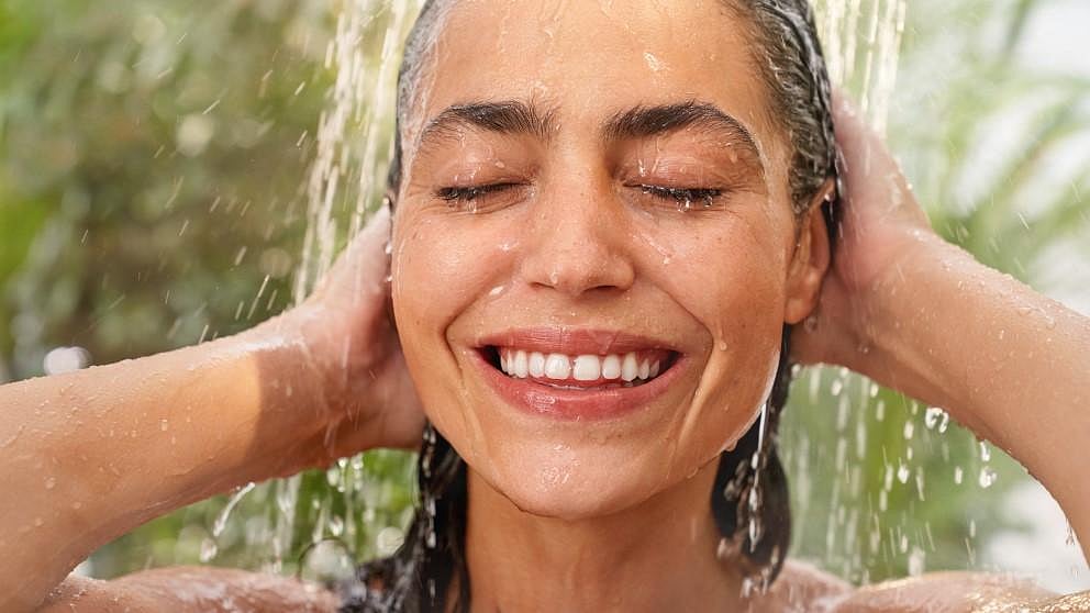 Woman smiling in shower.