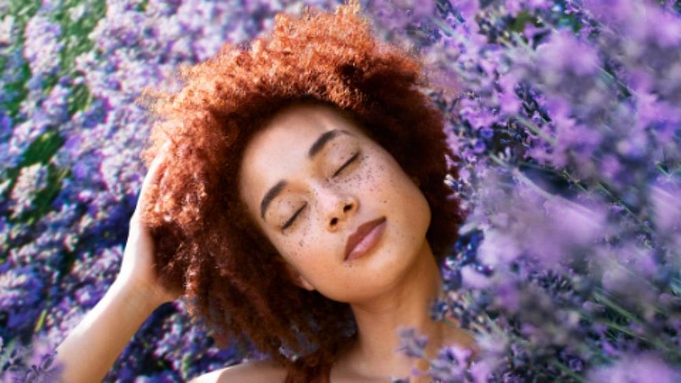Girl in a bed of purple flowers.