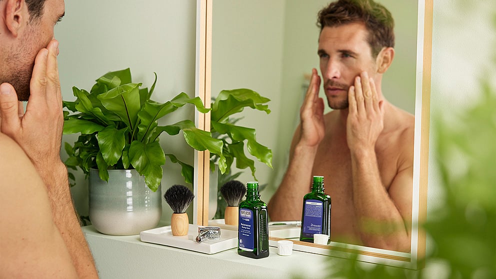 Man applying after shave balm to his face.