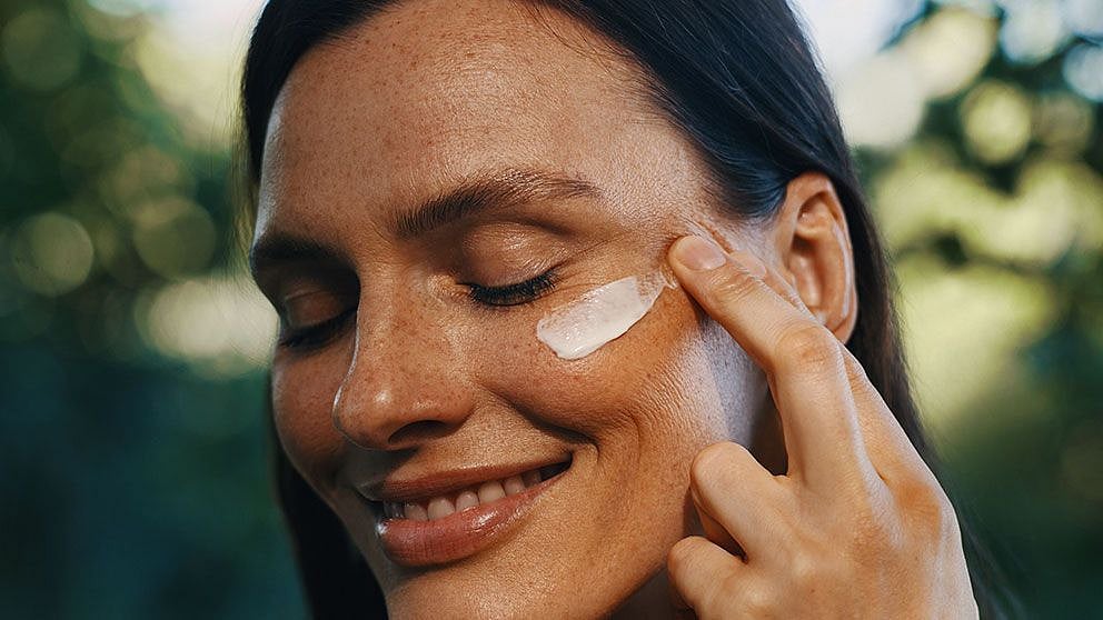 woman applying cream to her face