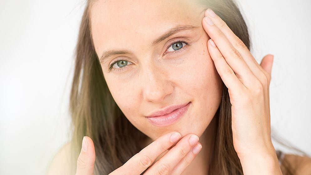 woman touching her face