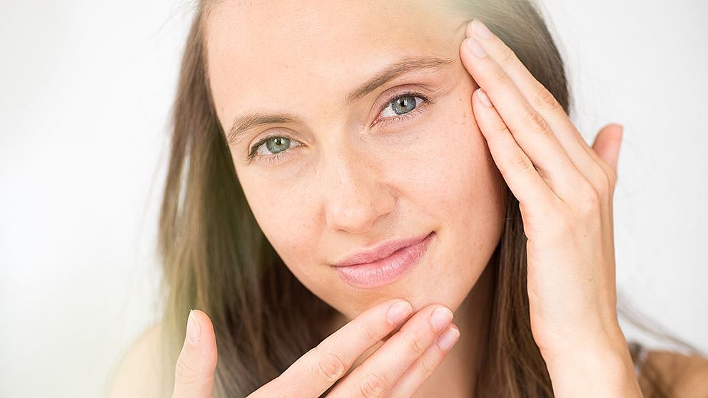 woman touching her face